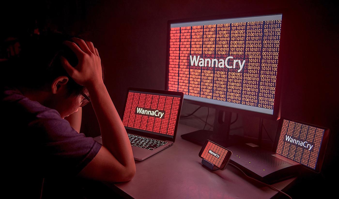 Young Asian male confused and headache by WannaCry ransomware attack